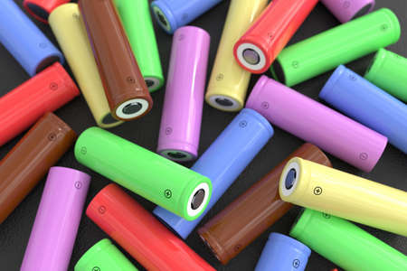 Lots of cylindrical batteries of different colors scattered on a black table. Lithium-ion rechargeable batteries for electrical devices. Galvanic cellsの写真素材
