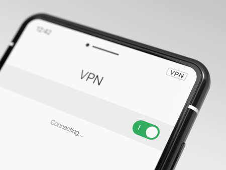 Black smartphone with VPN enabled, close-up. Modern cell phone with VPN, on a light background. Using a VPN on a smartphone. Selected focusの写真素材