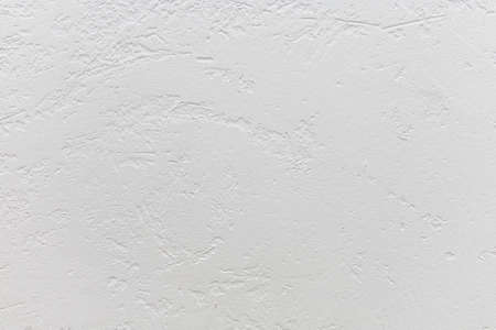 White rough texture or background. Decorative wall covering with white plaster. Rough white wall. Texture or background for designの写真素材