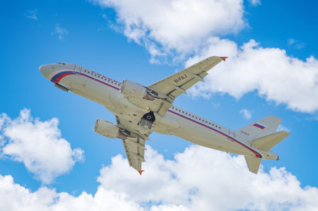 Takeoff of a jet Airbus A320-214 of ROSSIYA airlines, with tail number EI-FAJ against a blue sky...