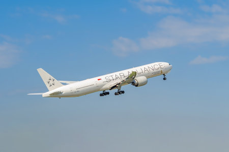 White Boeing 777 9V-SWI of Singapore Airlines takes off. Jet plane on the background of the blue sky. International passenger air transportation. Moscow Domodedovo Airport, Russia - May 23, 2014のeditorial素材