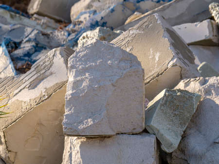 Concrete debris, pieces of cinder blocks and other construction waste. Illegal dump of construction waste. Environmental pollutionの写真素材
