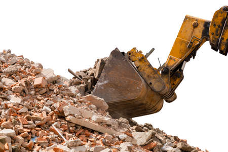 Frontal hydraulic loader forms a pile of construction debris with a bucket. Pile of broken red...