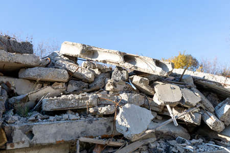 Fragments of a destroyed concrete building. The wreckage of a demolished building. Reinforcing bars and broken concrete. Pile of concrete debris. Construction debrisの写真素材