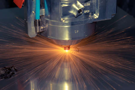 Laser cutting steel. Automatic laser cutting machine cuts shaped parts out of stainless steel....