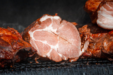 Smoked pork neck. Street food. Meat in the smokehouse. Dark crust with spices. Natural meat product...