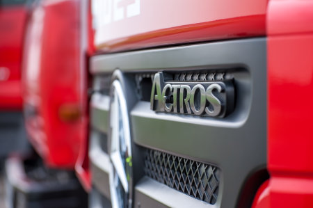 The cab of the Mercedes-Benz Actros truck in red. Close-up of the nameplate with the model name...