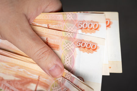 Mens hands count Russian rubles with a face value of five thousand rubles. Russian 5000 banknotes....