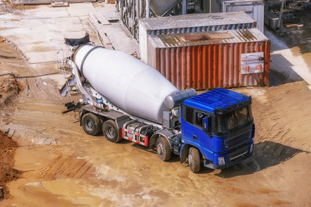 4-axle concrete mixer at a construction site. Heavy wheeled construction equipment. A truck for...