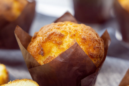 Cupcake in a paper wrapper close-up at some event or party. Muffin for breakfast. Dessert for...