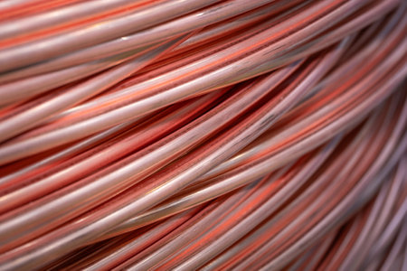 Twisted copper cable, close-up. Closeup of spiral copper cable with soft focus background. Copper wire randomly wound into a coilの写真素材