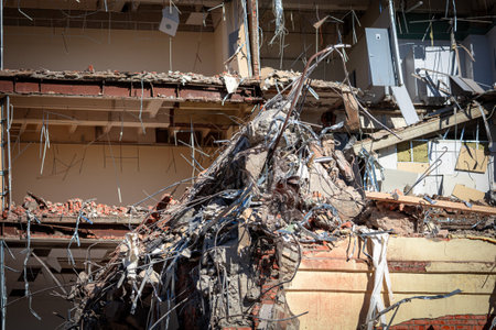 A destroyed fragment of a building with broken internal ceilings, torn off doors and fragments of walls. Result of earthquakes or military conflictの写真素材