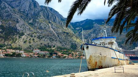 Old boat at the pier in kotor fjord bay montenegroの写真素材