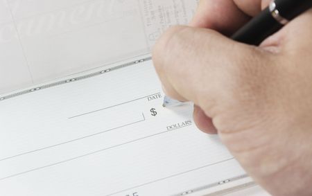 Macro, writing a check with a black pen.の写真素材