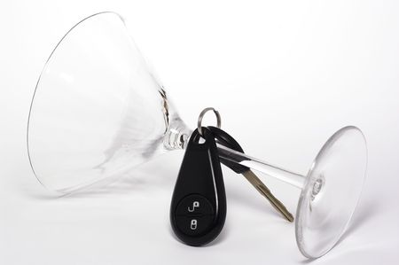 Knocked over martini glass with car keys over the stemの写真素材