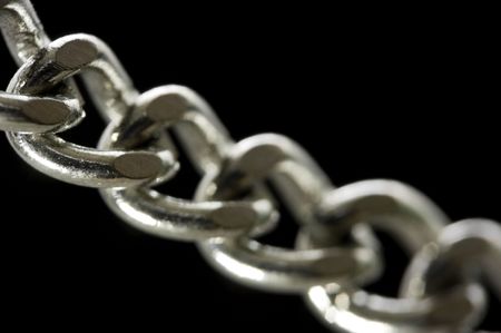Chain macro with shallow depth of field over black