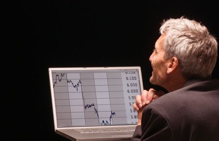 desperated man with charts on his laptop