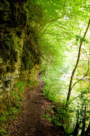 hiking trail in the Black Forest between rocks and riverの写真素材