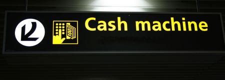 airport sign with directions to cash machineの写真素材