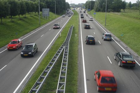 not too heavy traffic on two two-lanes highway with a slight motion blurr on cars