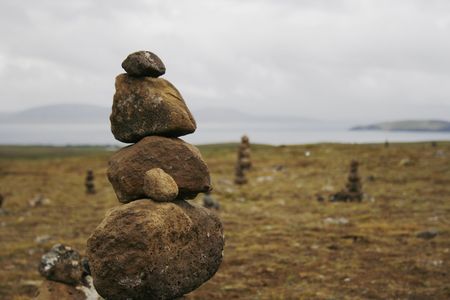 Tower of balancing stones in a rugged landscapeの写真素材
