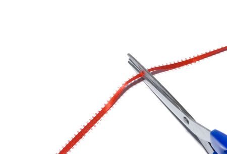 scissors cutting a ribbon isolated on white