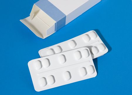 two packages of pills and a box