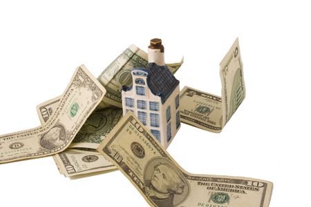 a white and blue house standing with dollar bills around it. Isolated on whiteの写真素材