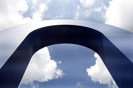 blue arch against a blue and white skyの写真素材