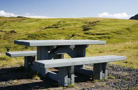 wooden picknick bench in green landscape in Icelandの写真素材