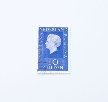 Blue expensive vintage postage stamp of the Netherlands with Queen Juliana (1909-2004). Worth ten guilders.のeditorial素材