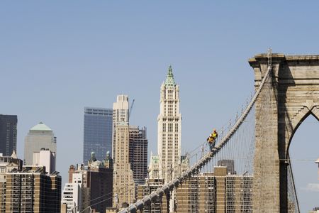Two workers on Brooklyn bridge in Manhattan checking the ropes with mirrors on terrorist items