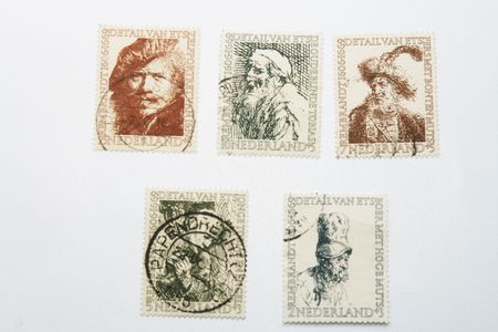 Five old Dutch postage stamps with paintings of Rembrandt and postmarksのeditorial素材