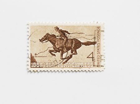Vintage usa postage stamp of Pony express of 1960. To commemorate the hundred years anniversary of the Pony Express between Sacramento and St. Josephの写真素材