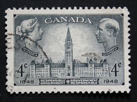 Vintage Canadian postage stamp with images of Queen Victoria and King George VIのeditorial素材