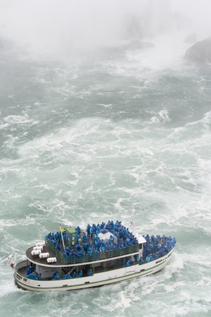 Excursion boat at Niagara Falls with people in blue raincoatsの写真素材