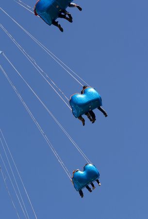Amusement park ride with blue cartsの写真素材