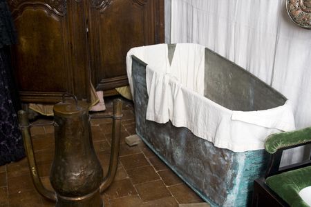 Bathroom from the 17th century in France with a metal bathtub and a copper water heaterの写真素材