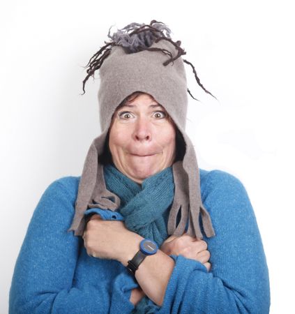 Shivering middle aged woman in funny felt cap and in blue sweaterの写真素材