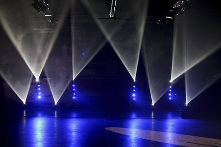 Blue and white spotlights on a stageの写真素材