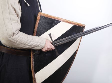 Male medieval soldier in traditional clothing with padded armour, long sword and shieldの写真素材