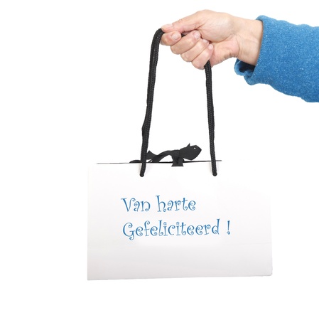 Hand in blue sweater holding white bag with black cord の写真素材