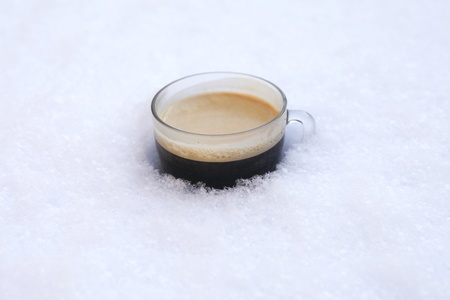 Hot coffee in cold snowの写真素材