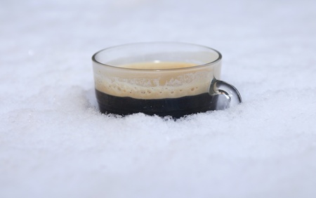 Hot coffee in cold snowの写真素材