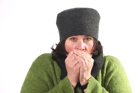 Woman blowing hot air in cold handsの写真素材