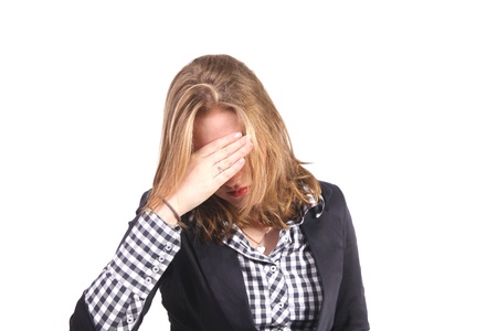 Woman with stress holidng hands against foreheadの写真素材