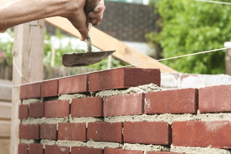 Trowel in hand of bricklayerの写真素材