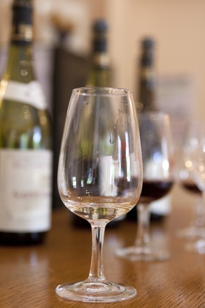 Glass with small amount of white wine at tastingの写真素材