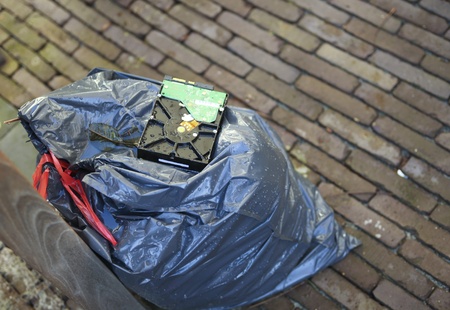 Crashed hard disk on a garbage bagの写真素材