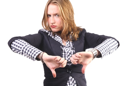 Young woman looking annoyed and giving the thumbs down gestureの写真素材